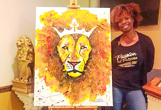 Artist Mia West with Lion of Judah Painting